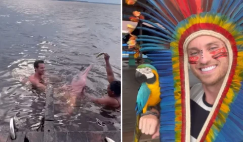 Lucas Bissoli, ex-participante de reality, nada com botos em visita a Manaus