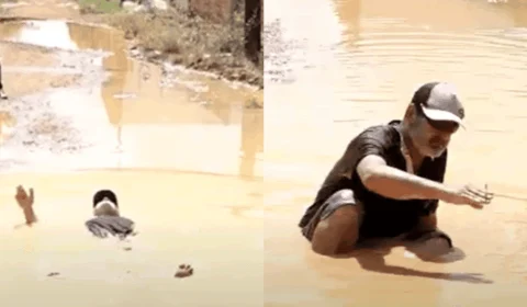 Morador se joga em vala de lama para protestar contra abandono de rua em Porto Velho