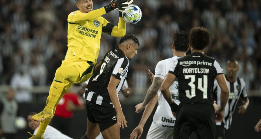 Tiquinho Soares disputa lance com Tadeu jogador do Goiás