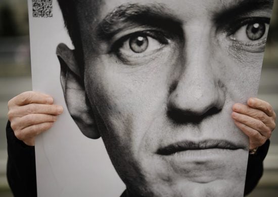 Um homem segura um pôster com um retrato do líder da oposição russa, Alexei Navalny, durante um protesto em frente à embaixada russa em Berlim, na Alemanha - Foto: Foto: Markus Scheiber/ Associated Press/ Estadão Conteúdo